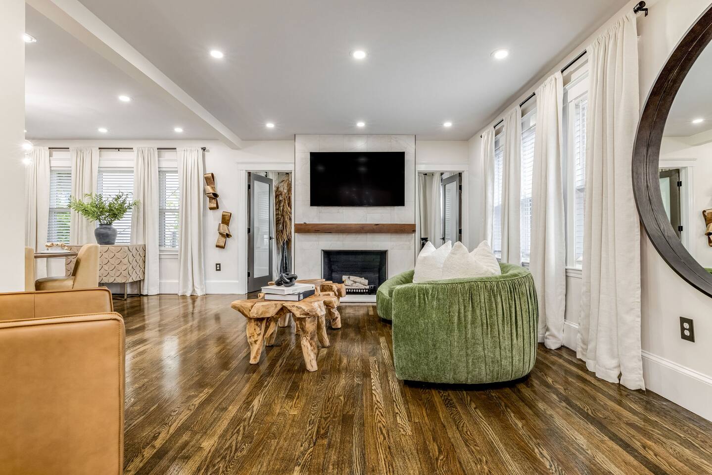 Bright and spacious living room with a fireplace , Smart TV, and designer furnishings.