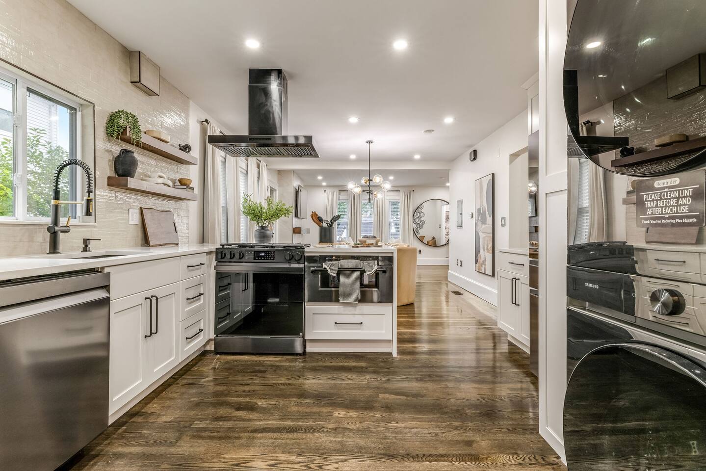 Fully equipped gourmet kitchen with an oversized island, premium appliances, and open-concept design.