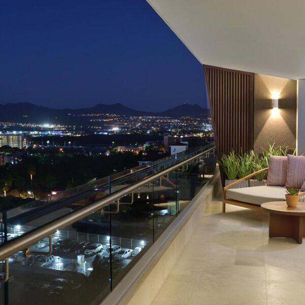 Modern private balcony with city lights and mountain views at night