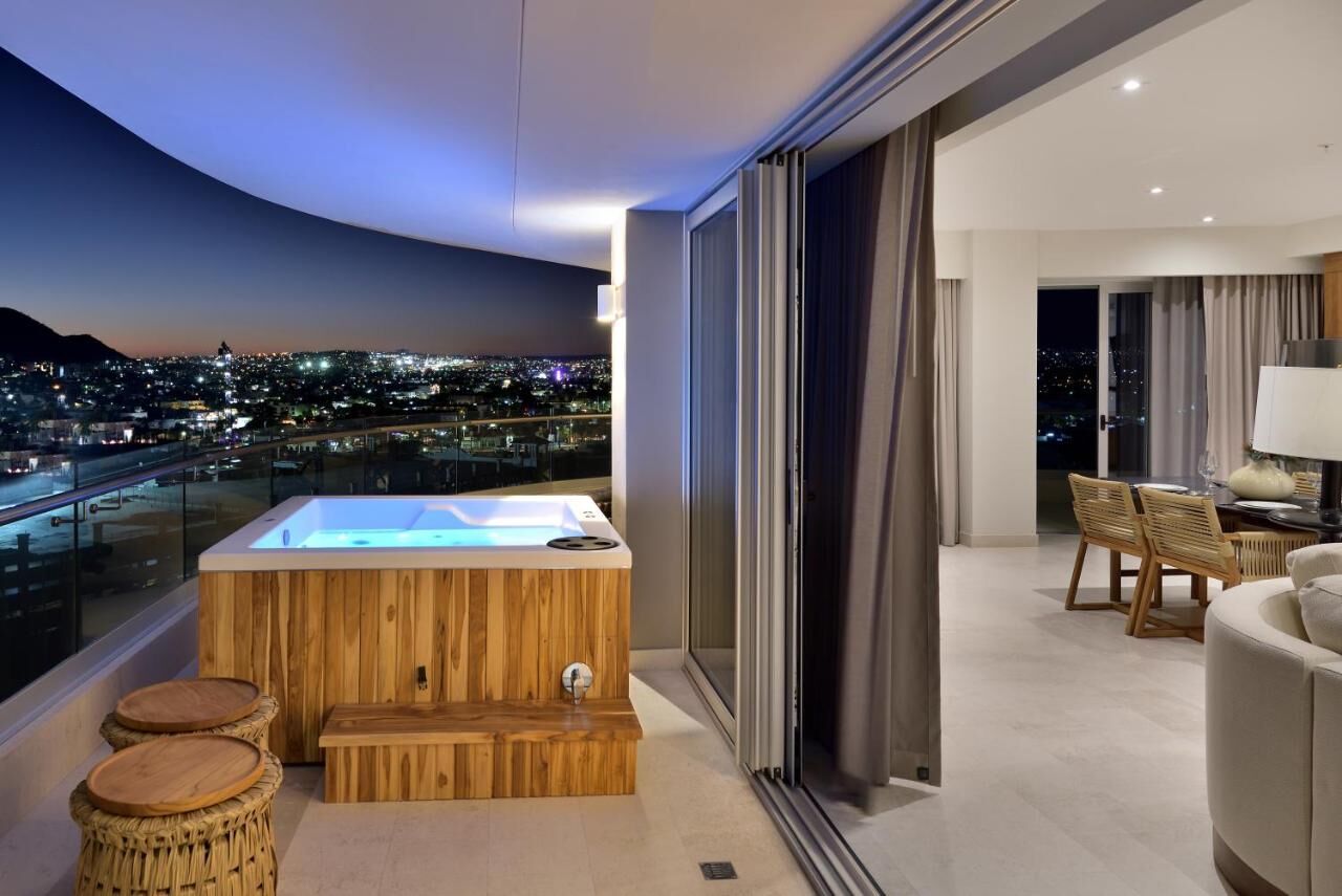 Private balcony hot tub with stunning city views at sunset