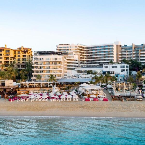 Beachfront resort with turquoise water, loungers, and upscale coastal views