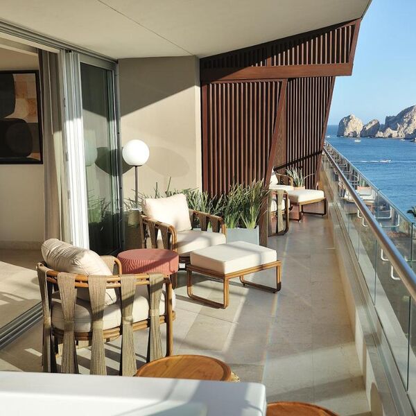 Stylish oceanview balcony with lounge seating and stunning coastal views