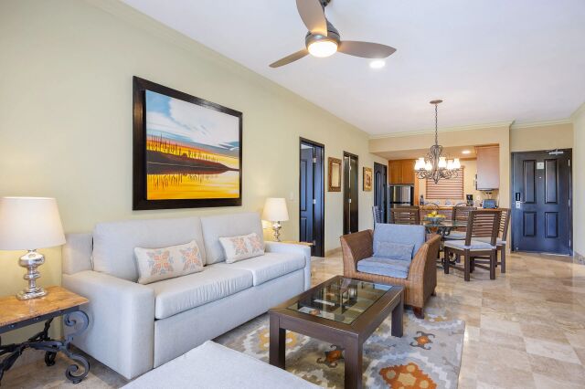 Bright open living space with stylish seating, dining area, and full kitchen