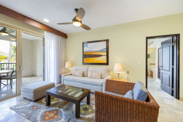 Bright coastal living room with balcony access and stylish seating