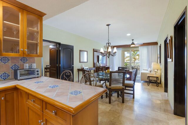 Bright open kitchen and dining area with tropical light-filled views