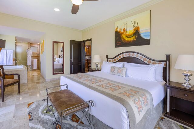 Spacious king suite with elegant decor, vanity area, and resort-style comfort