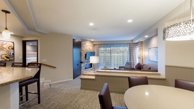Spacious open living area with fireplace, dining space, and natural light