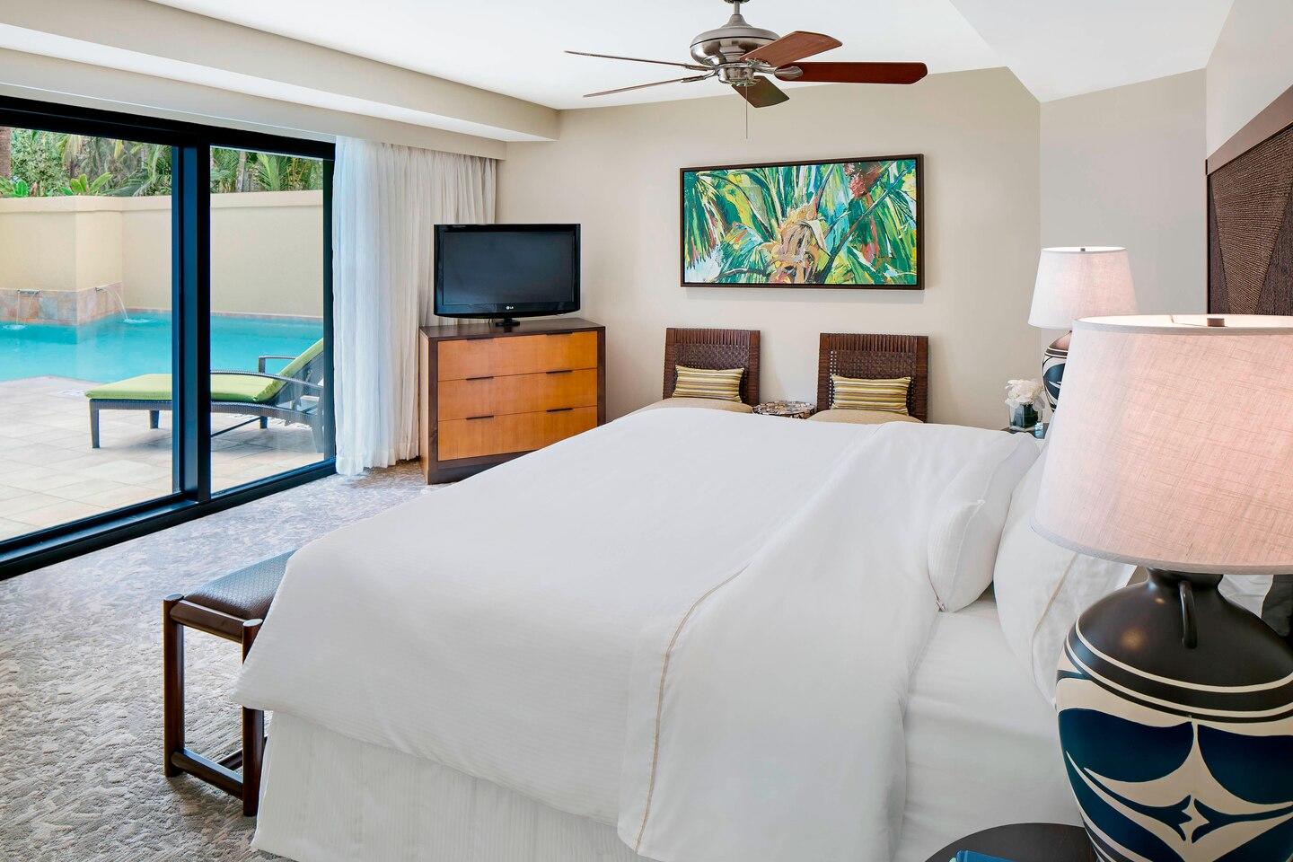 Spacious bedroom with pool access and serene indoor-outdoor style