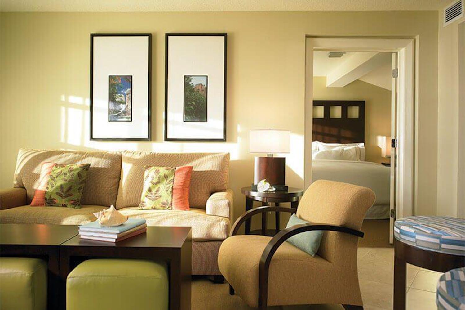 Bright suite-style living room with cozy seating and separate bedroom