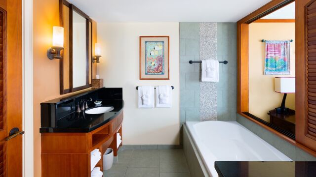 Spa-like bathroom with soaking tub, elegant vanity, and warm wood accents