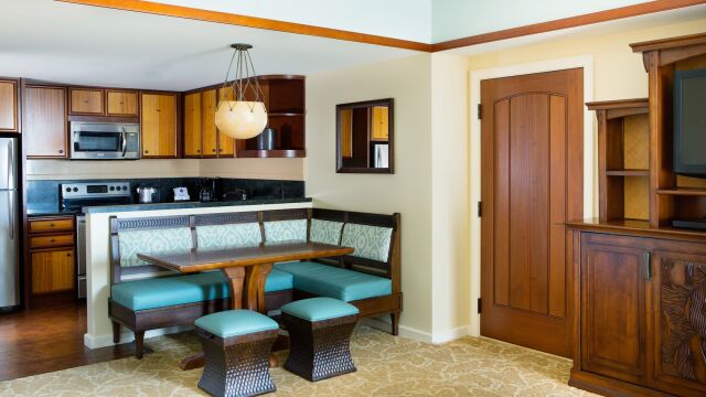 Cozy breakfast nook and full kitchen with warm wood finishes