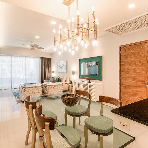 Bright open living-dining space with chandelier and elegant modern decor