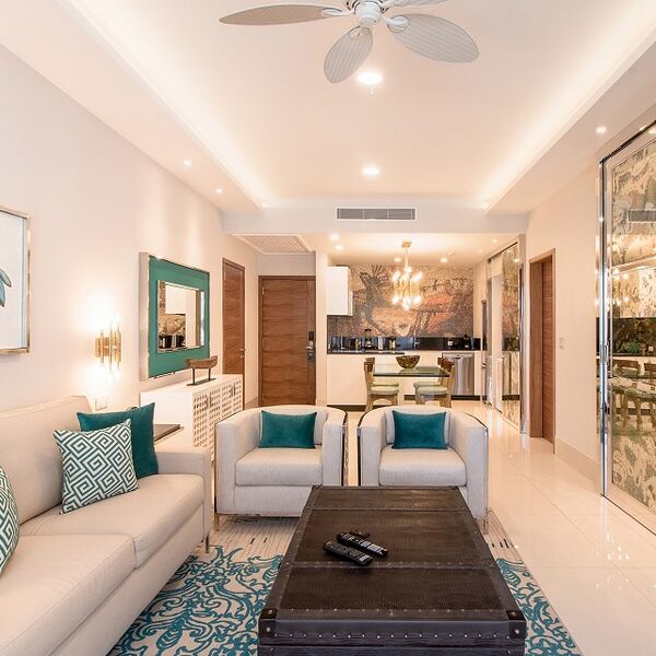 Bright open-plan living with chic decor, dining area, and modern kitchen