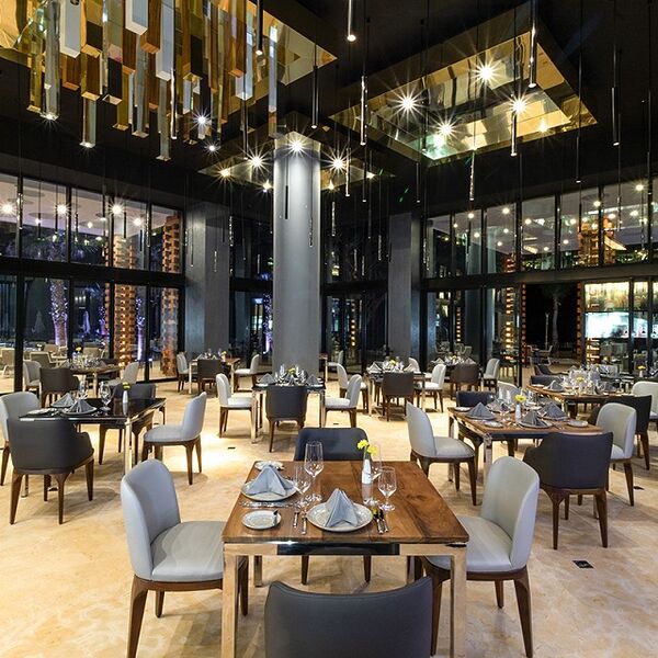 Elegant high-ceiling restaurant with modern lighting and upscale ambiance