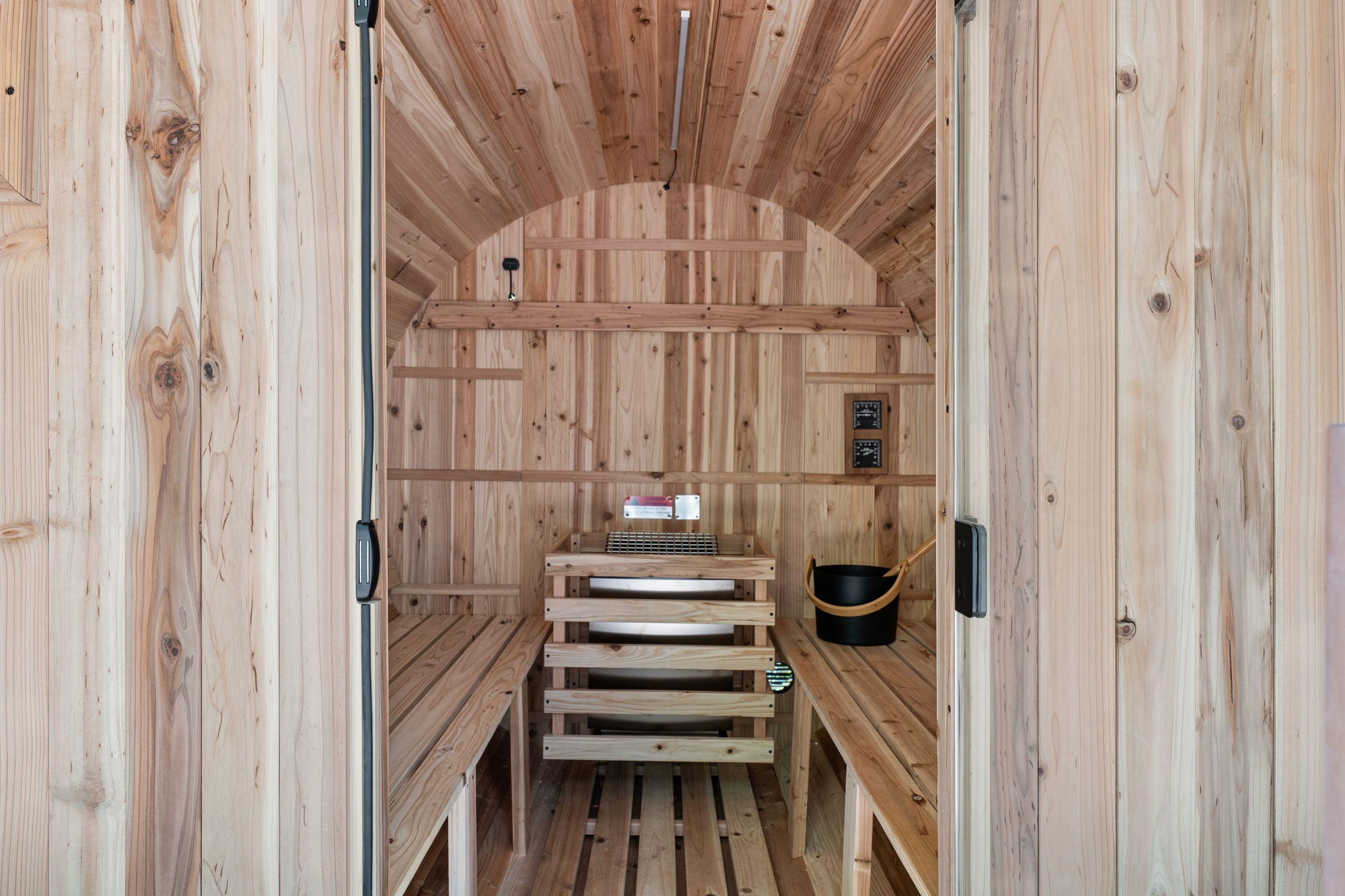 Warm cedar envelops you: step into the barrel sauna and melt into the ritual of heat and silence.