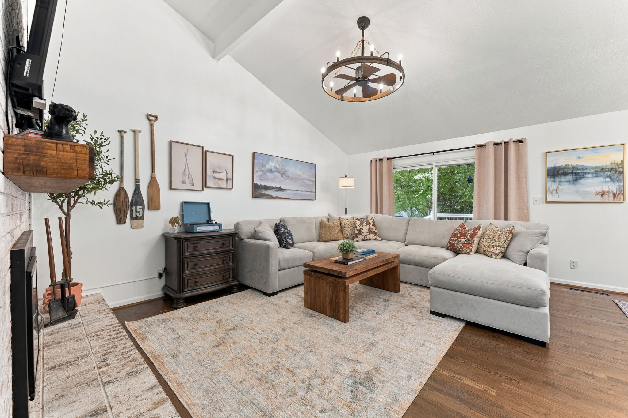 A second living room to breathe in: soaring ceilings, woods and lake views, and space enough for everyone to sprawl.