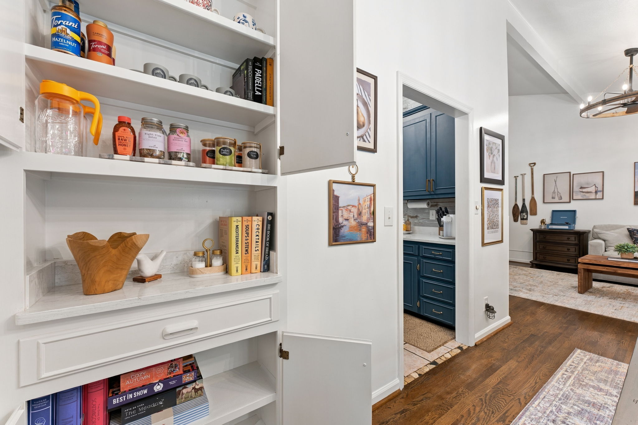 Italian ingredients and leather-bound cookbooks lined up like treasures: a pantry that celebrates the art of cooking.