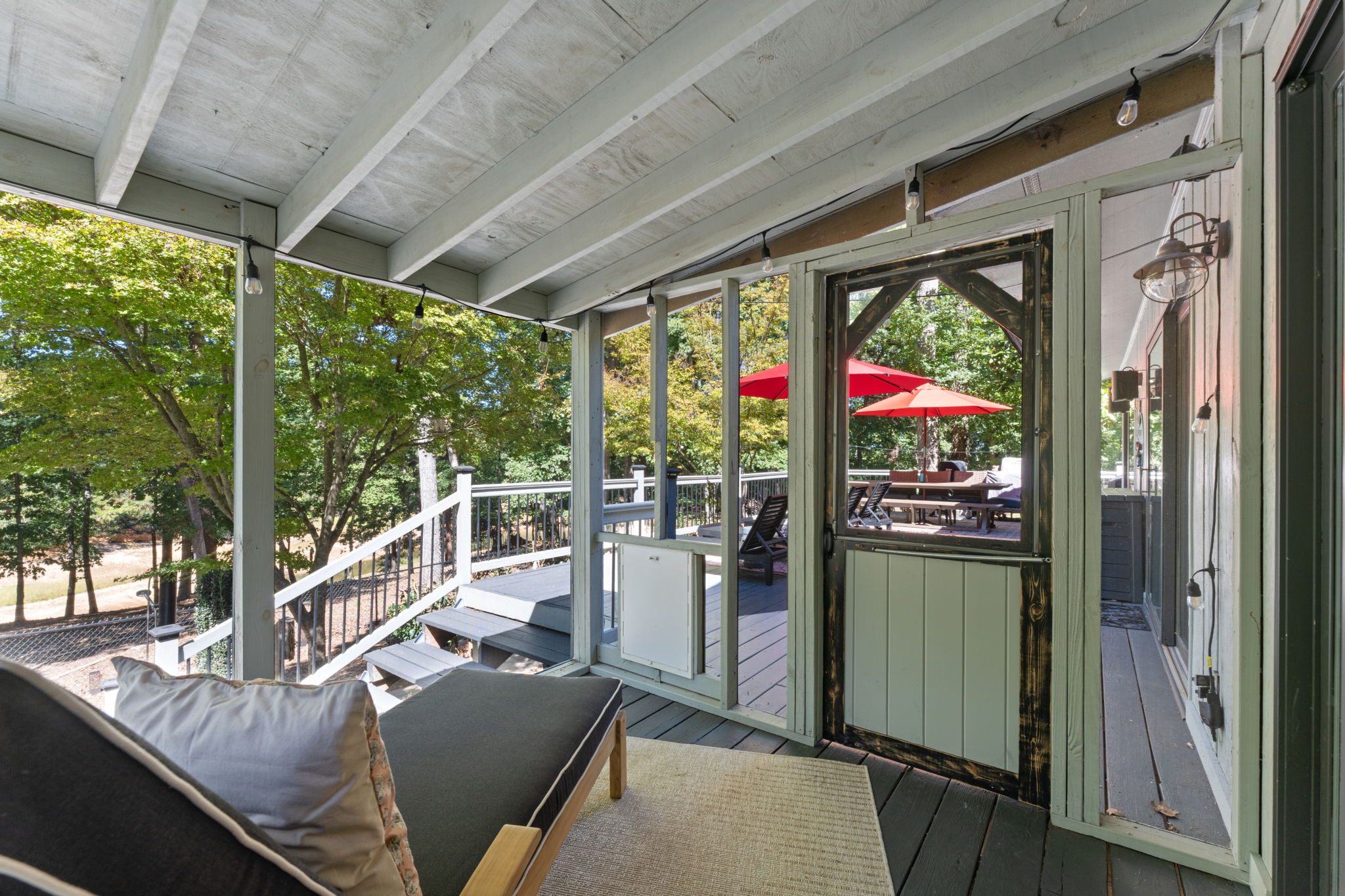 no glass - screen  Screened porches wrap the view: sit inside the forest without a single bug, every breeze yours alone.