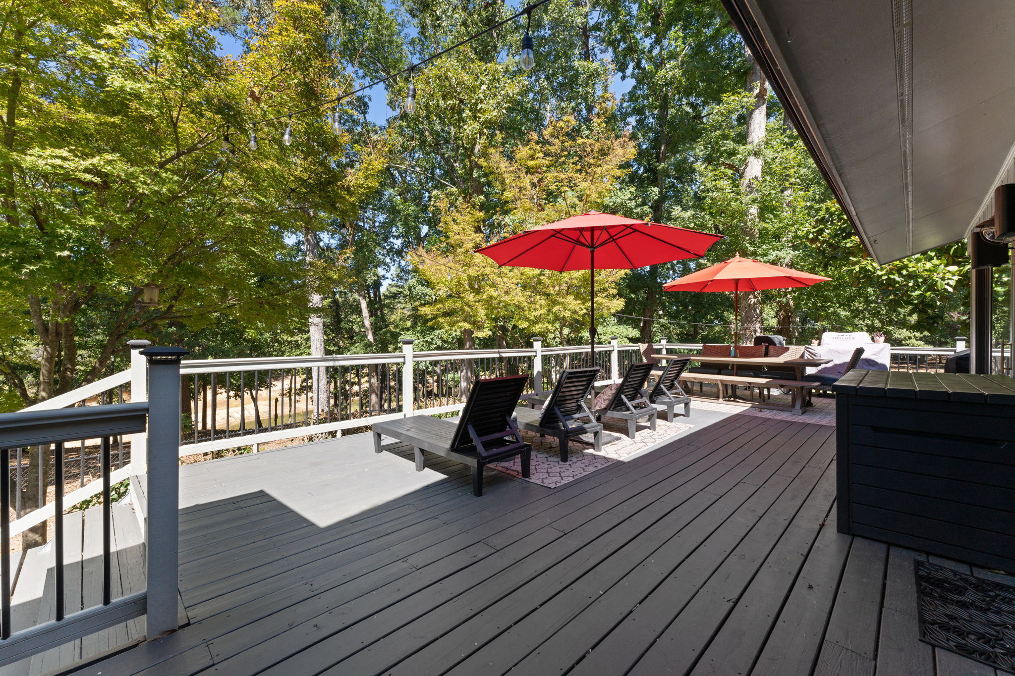 Gather here: lounge chairs face a table ready for dinner, and a wood-fired pizza oven waits to turn flour and flame into Italian magic.