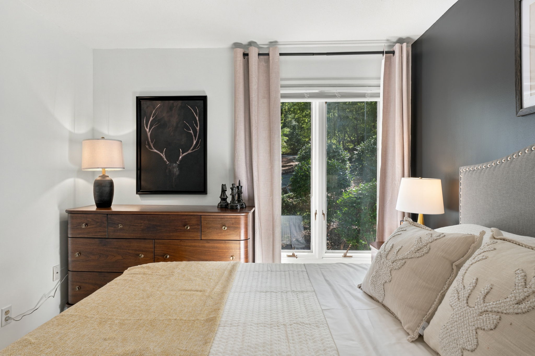Bright, cozy bedroom with garden views and elegant neutral decor