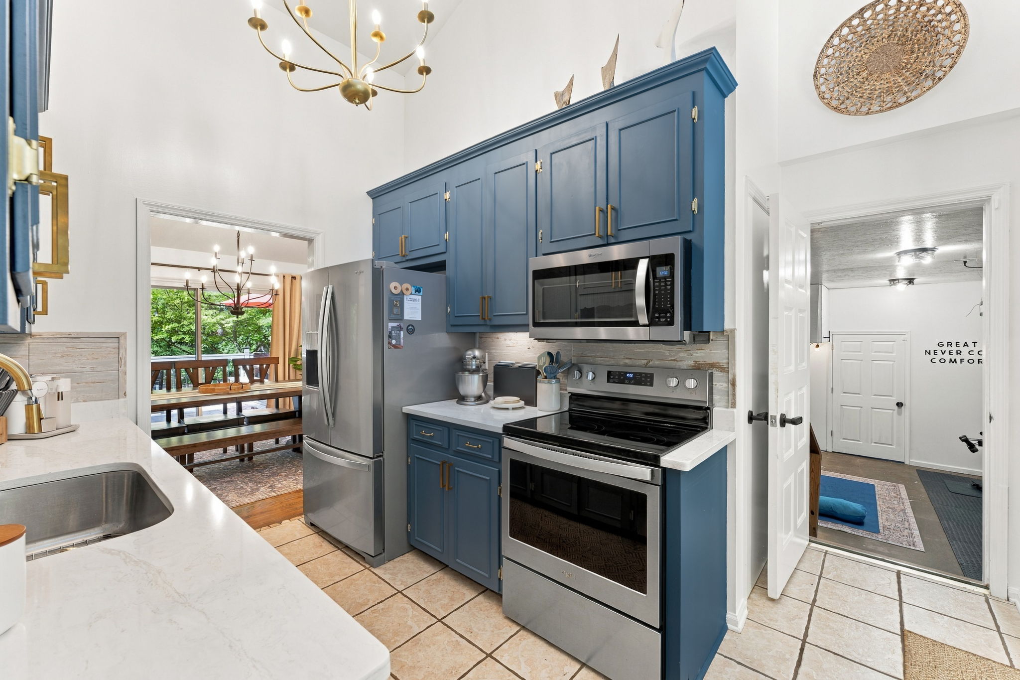 Cook in style where blue cabinetry and stainless steel meet, then step straight into gathering space.