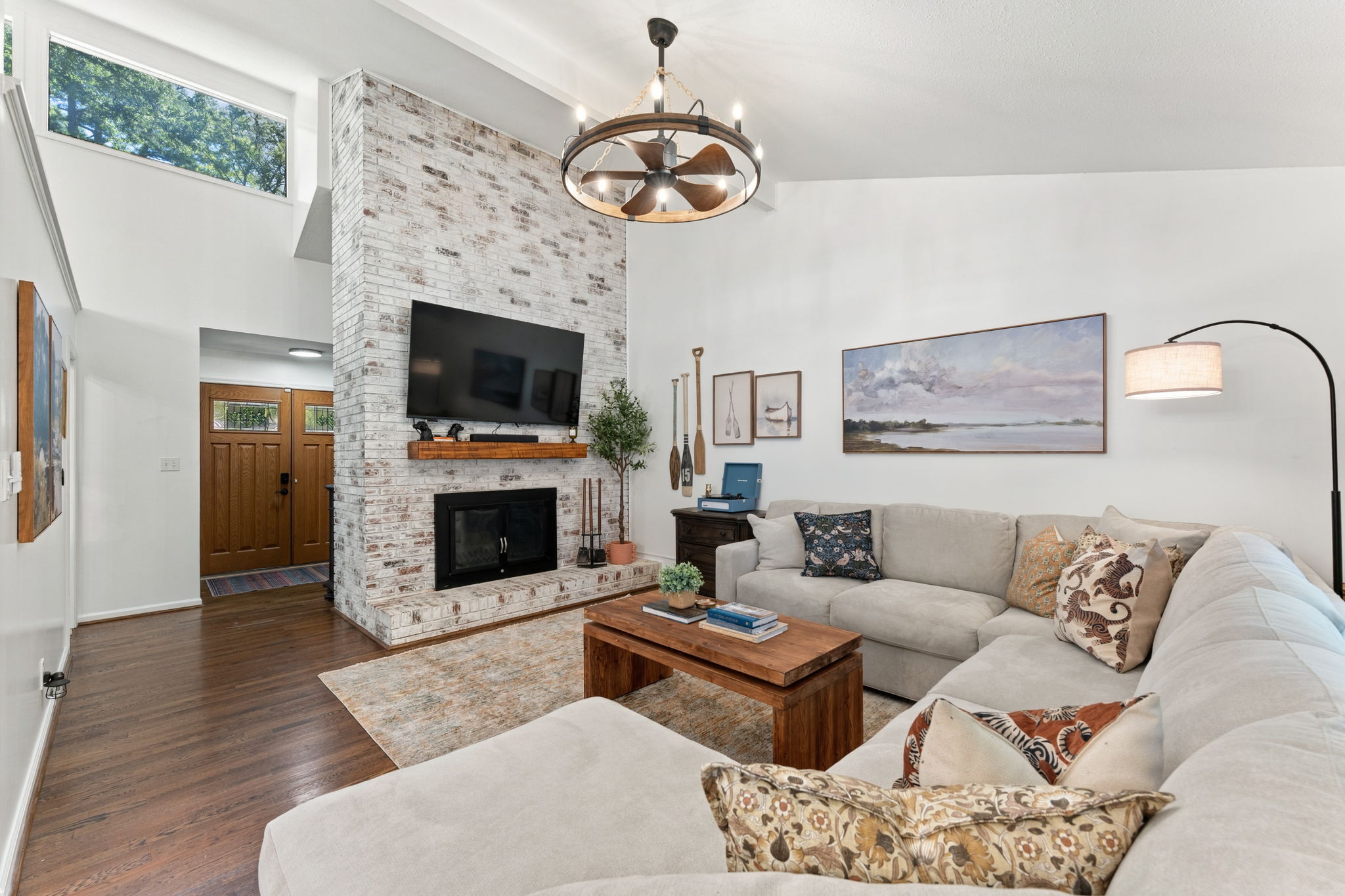 Soaring ceilings, a working fireplace, and light that fills the room: the gathering place where lake views and comfort meet.