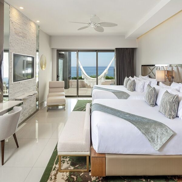 Stylish double-queen room with private terrace, hammock, and ocean views