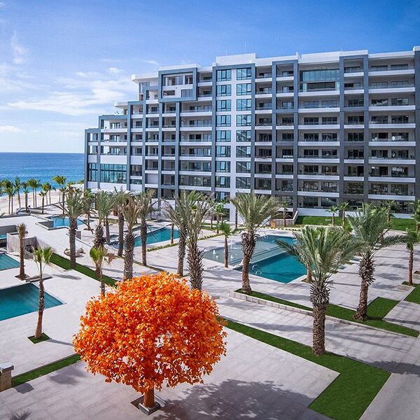 Modern beachfront resort with pools, palm-lined grounds, and ocean views