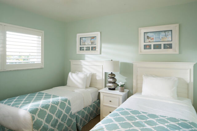 Bright twin bedroom with coastal decor and cheerful natural light