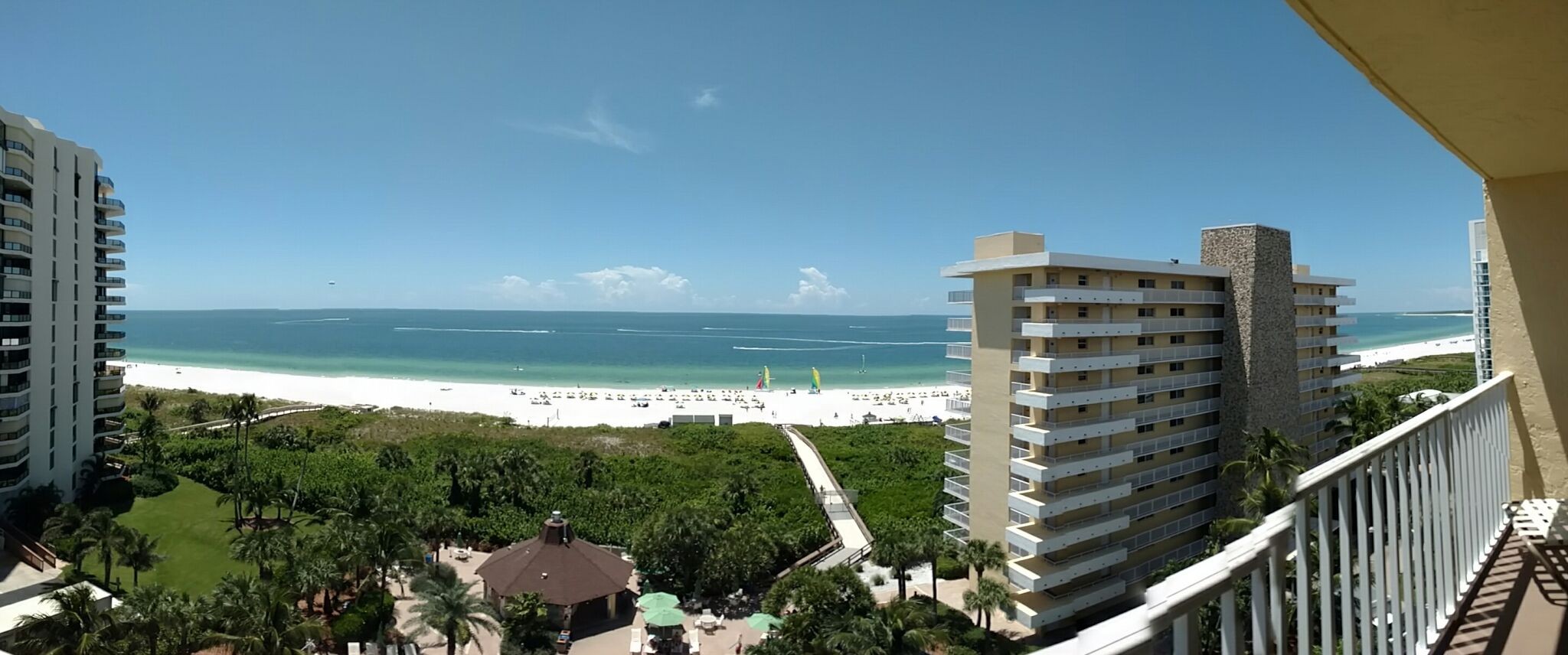 Sweeping balcony views of turquoise water and sugar-white beach