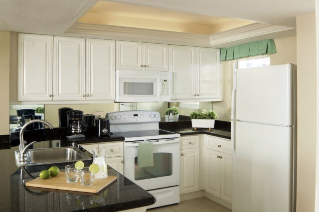 Bright full kitchen with breakfast bar, coffee station, and natural light