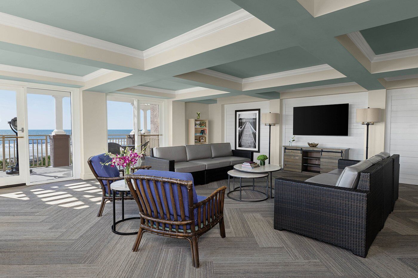 Bright oceanview lounge with balcony access and stylish, spacious seating