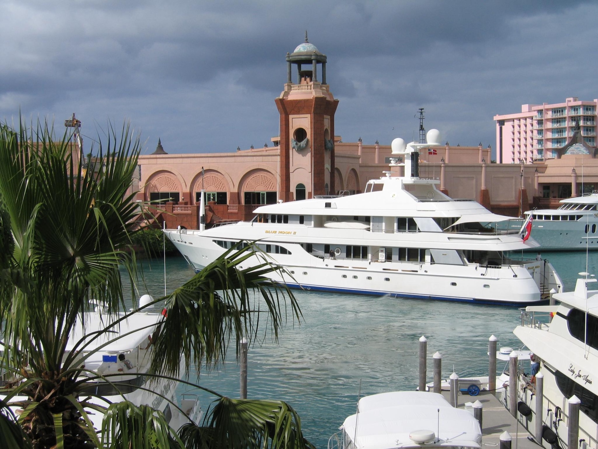Luxury marina views with yachts, tropical palms, and resort-style charm