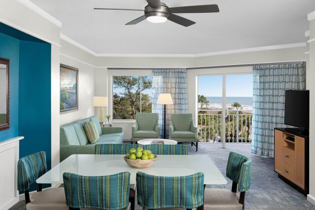 Bright coastal living room with balcony access and relaxing ocean views