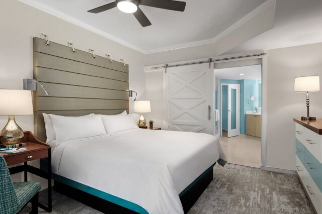 Bright king bedroom with barn door and en suite bathroom access