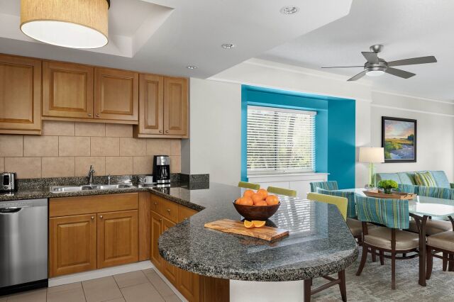 Bright open kitchen with granite island and cheerful dining nook