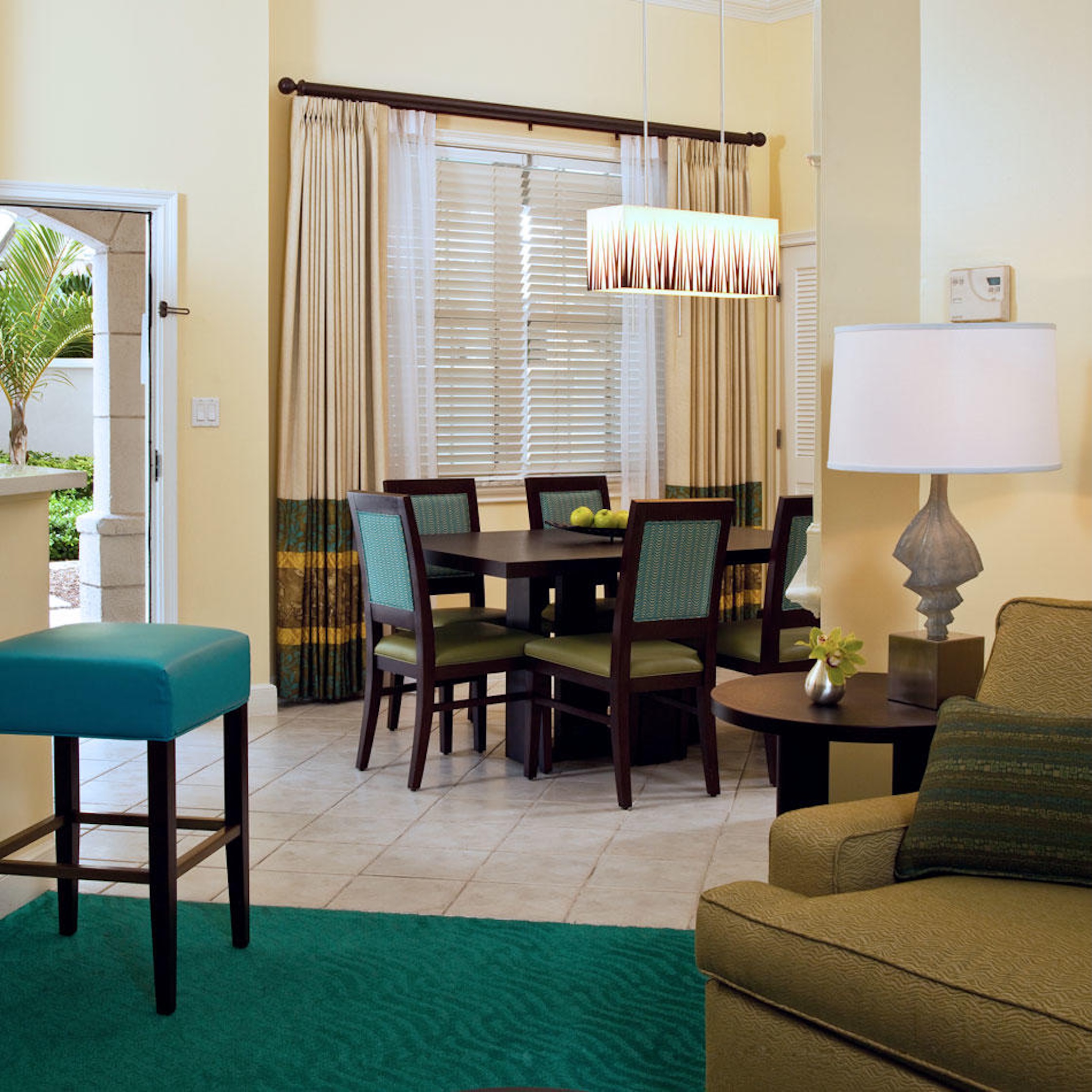 Bright open dining area with stylish seating and modern tropical accents