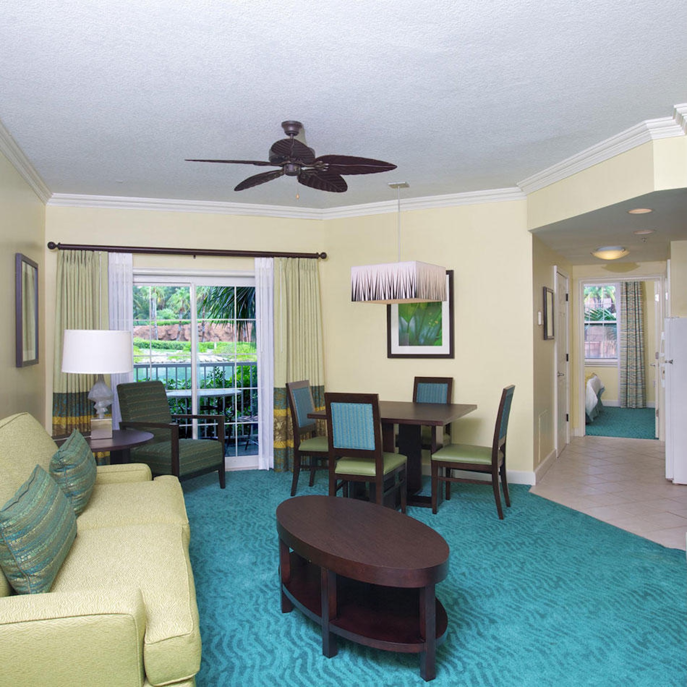 Bright tropical living area with patio access and dining for four