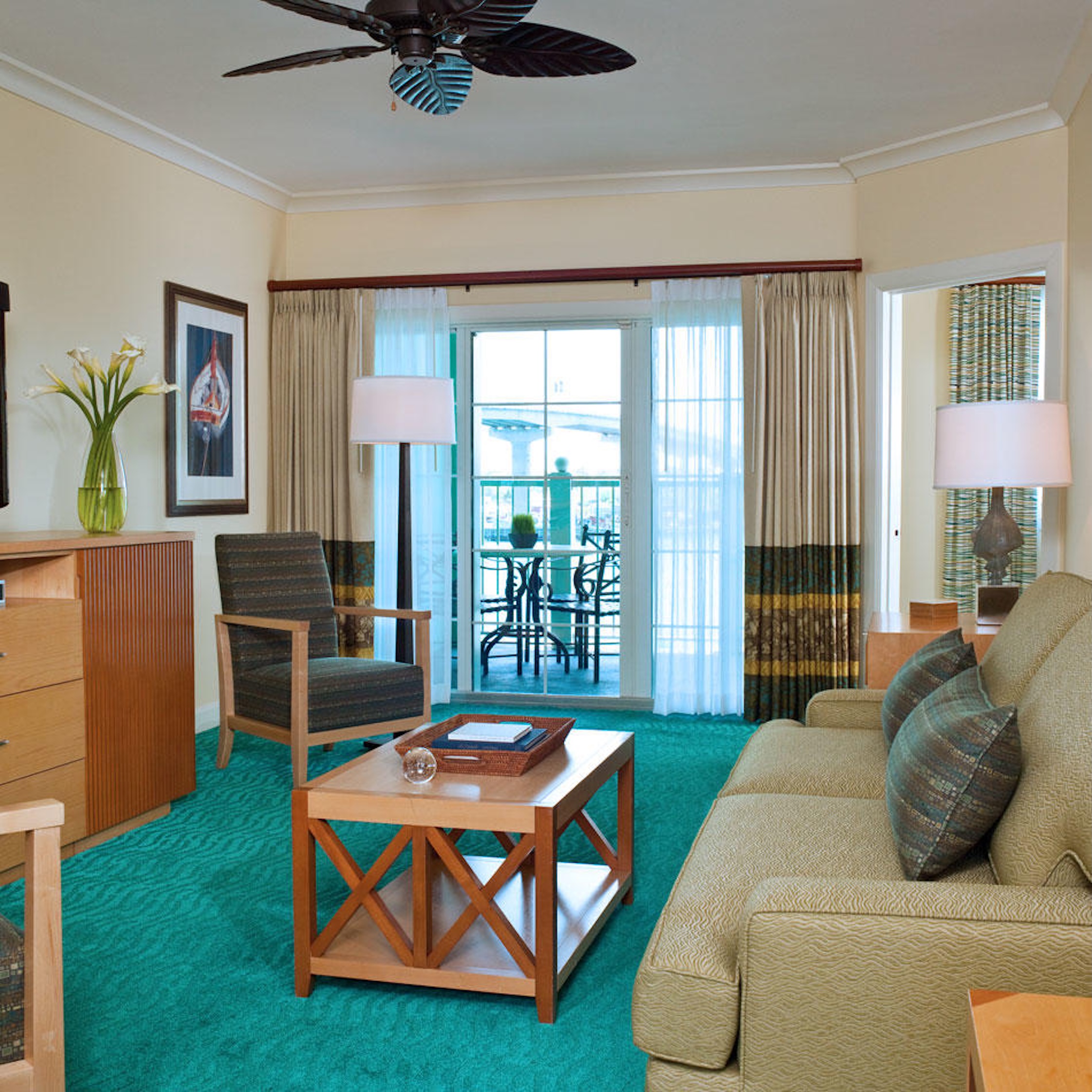 Bright living room with private balcony and relaxing water-view seating