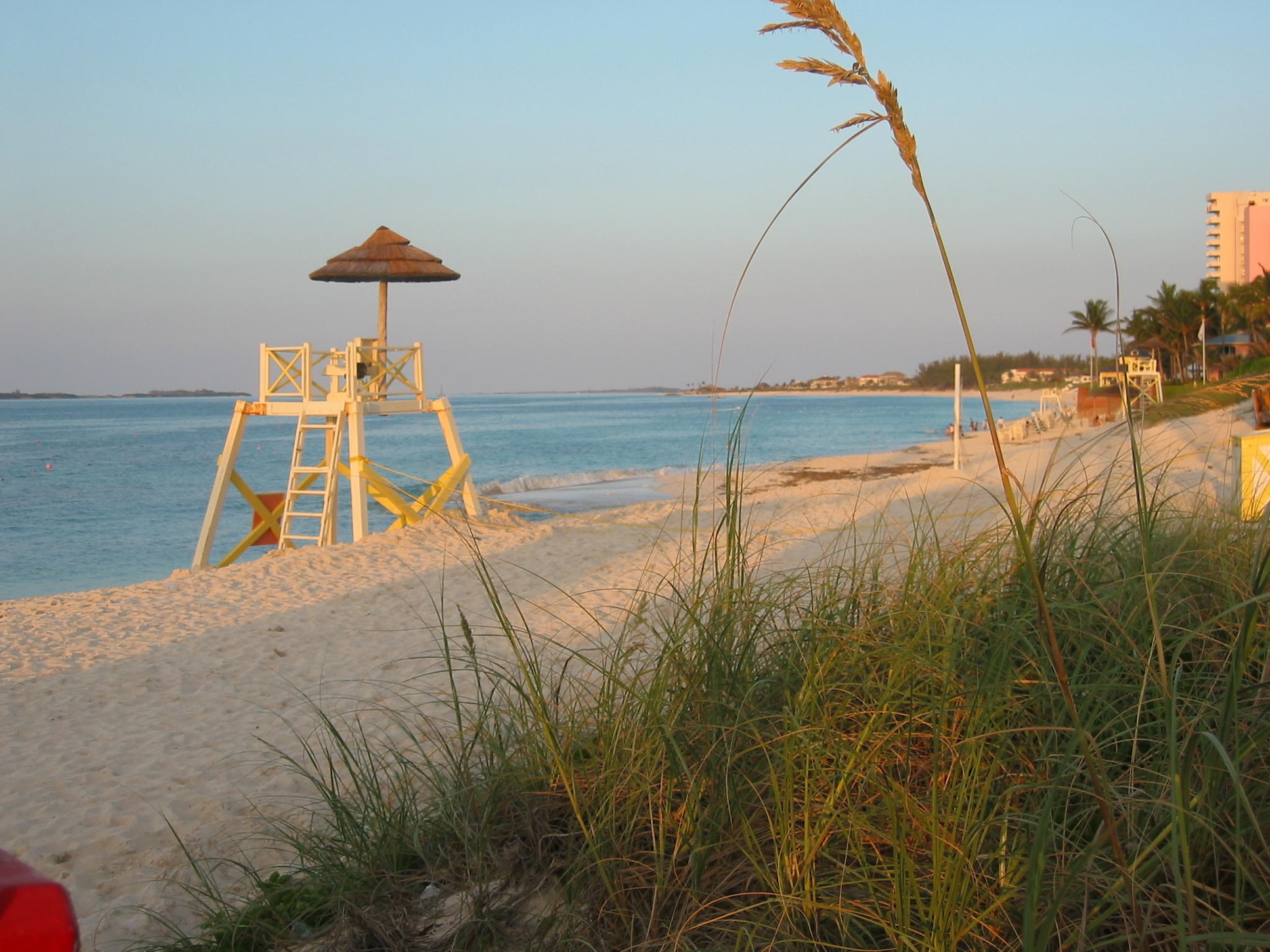 Peaceful beachfront with calm turquoise water and golden-hour charm