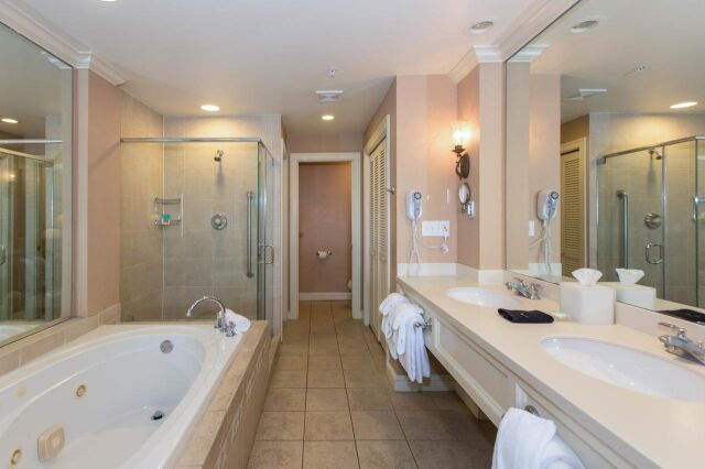 Spacious spa-style bathroom with soaking tub, glass shower & double vanity