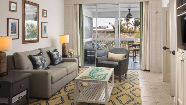 Bright tropical living room with private balcony and relaxing seating