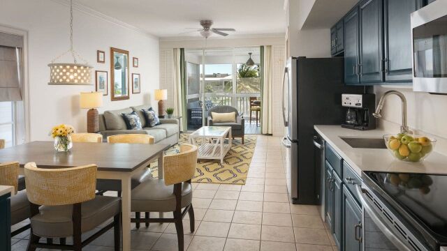 Bright open-concept condo with full kitchen, cozy living area, and private balcony