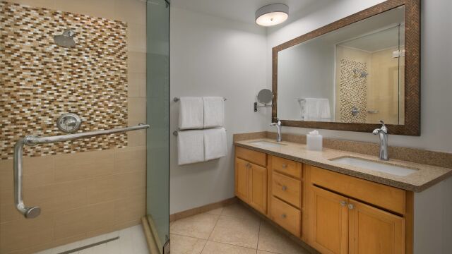 Spacious double-vanity bath with glass shower and stylish tile accents
