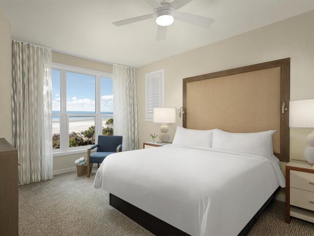 Bright coastal king bedroom with ocean views and serene natural light