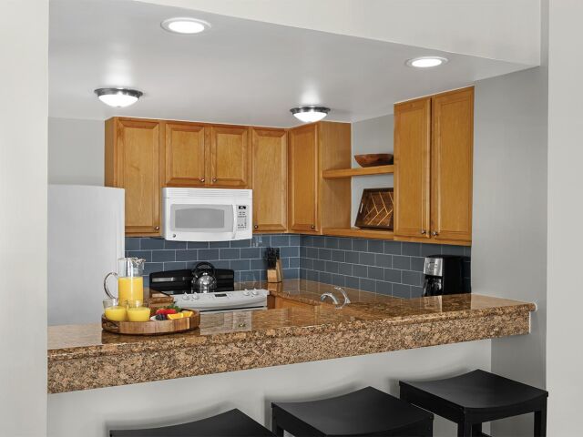 Bright kitchen with granite breakfast bar and stylish tile backsplash