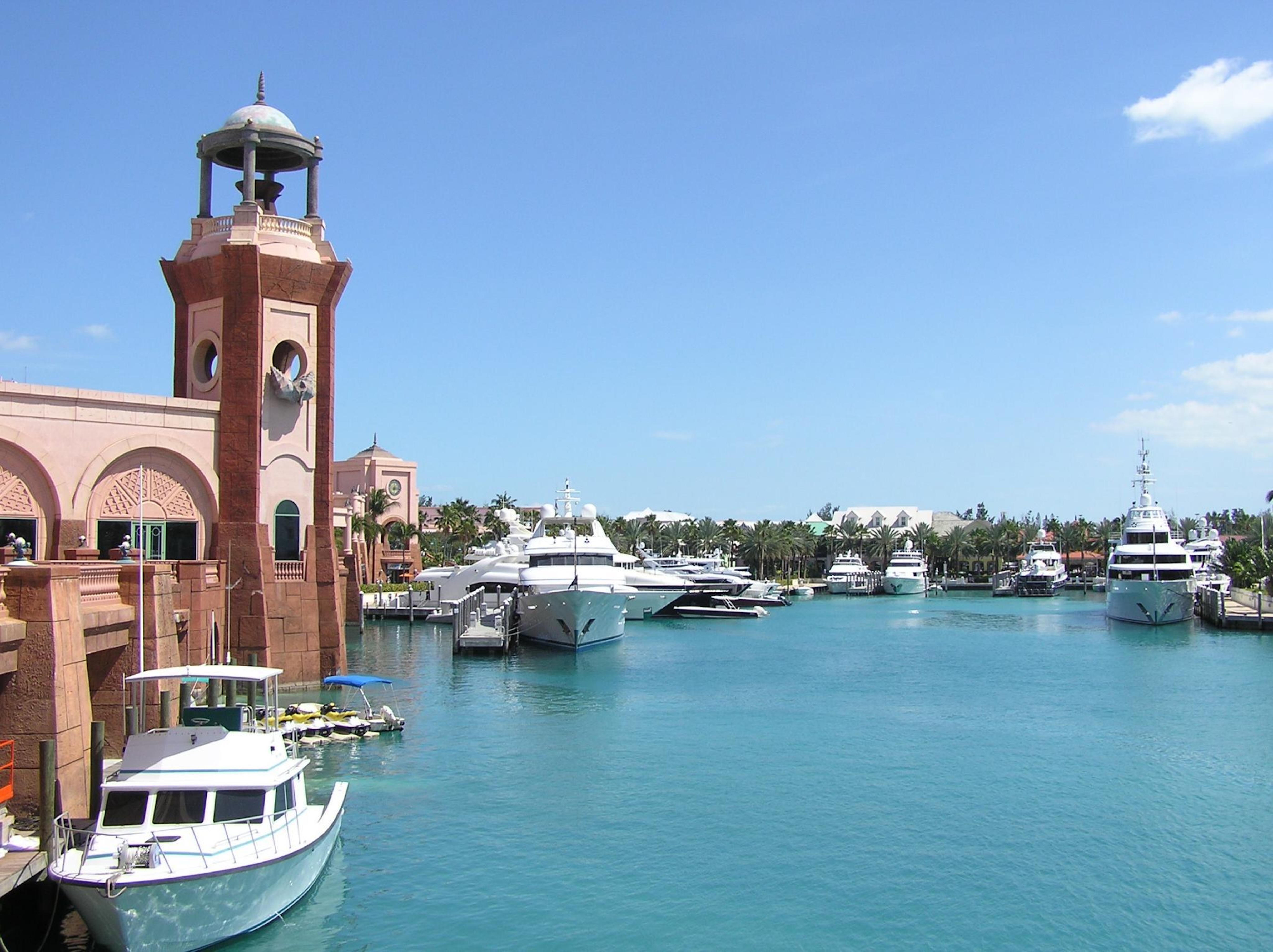Scenic luxury marina with yachts, turquoise water, and resort-style views