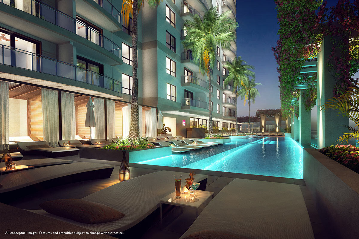 Resort-style illuminated pool with luxe loungers and tropical ambiance