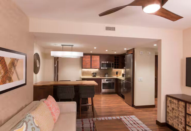 Modern open living space with full kitchen and breakfast bar