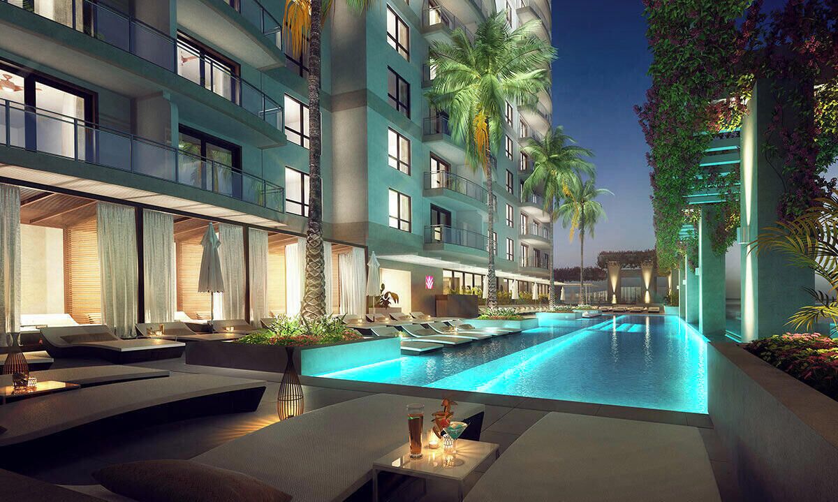 Resort-style illuminated pool with luxe loungers and tropical vibes